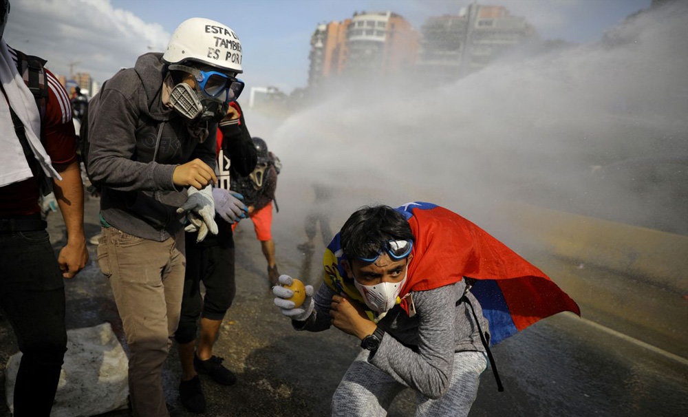 تصاویر : رویارویی خودروهای آبپاش با معترضان ونزوئلایی‎